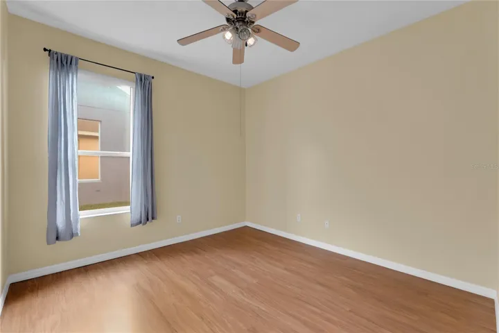 4th bedroom features ceiling fan, laminated flooring, large closet and a remodeled en-suite bathroom.