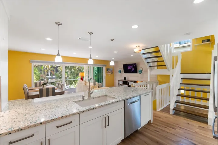 View of Dining Area and Living Room from Kitchen (stairs to bedrooms on 3rd floor)