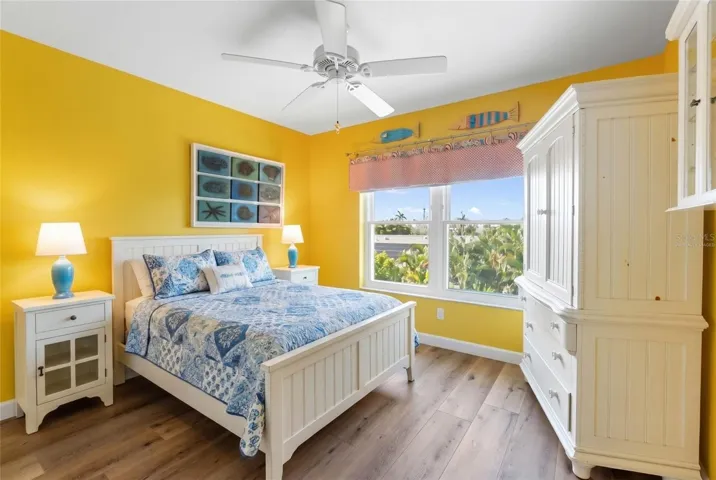 Bedroom 3 overlooks rear of home and pool/spa (photo virtually staged with Bed)