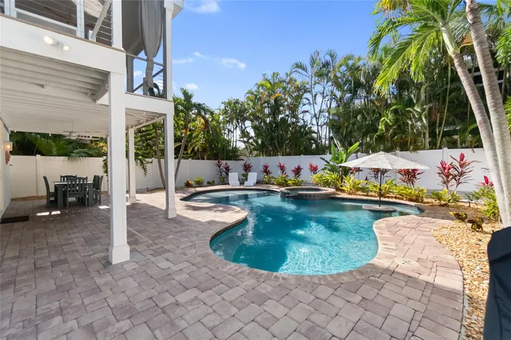 Crystal Blue Waters of the Pool and Spa await, with built-in Sundeck and Table with Umbrella