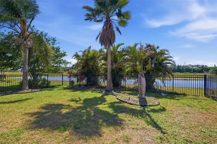 Fenced in backyard overlooking a pond