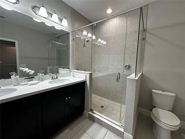 Master bathroom with double sink and linen closet.