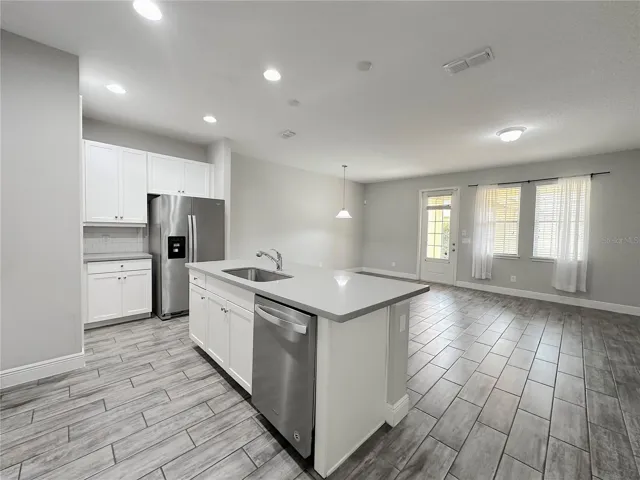 Modern open concept-high ceiling, kitchen, living and dinning area