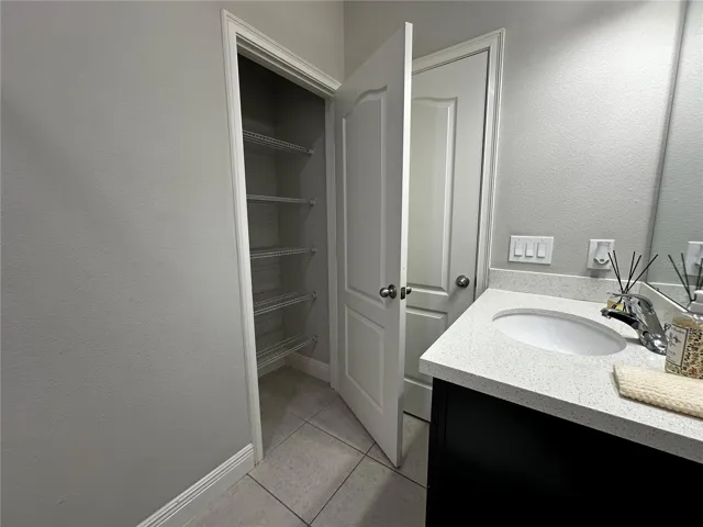 Full bathroom at second floor with linen closet.