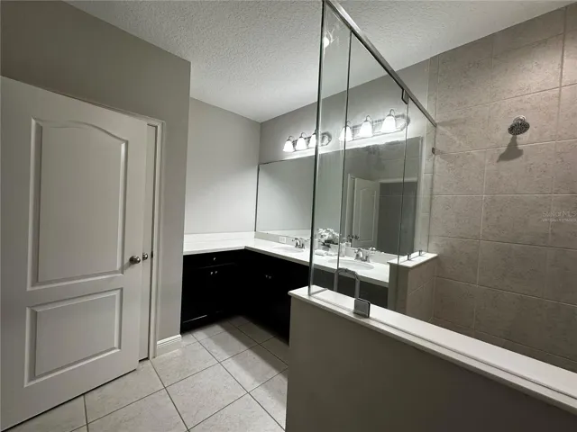 Master bathroom with double sink and linen closet.