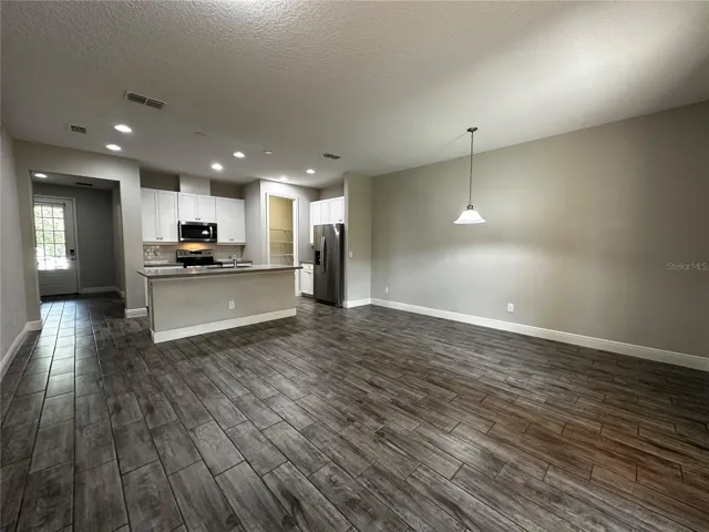 Open concept-high ceiling living room, dinning room and kitchen at first floor.
