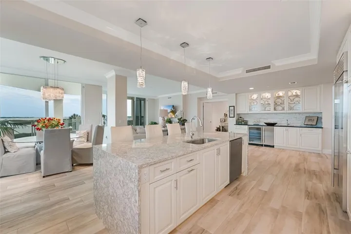 A great overview of your living area - showing the wet bar area, kitchen island and dining area