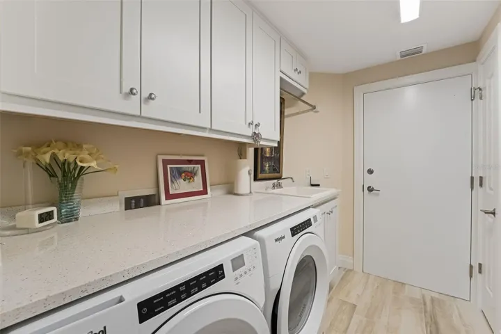 It is very nice to have a separate laundry room with storage, a sink and countertop space to fold the laundry.  Notice there is a 2nd door to leave the condo and use the stairs.  This door also leads to the trash shut for easy trash disposal.