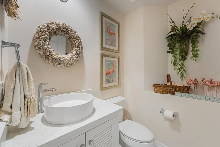 This is the half bath for guests - nicely done with coastal decor
