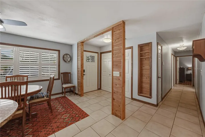 Wood accents, built-in wooden shelves and double closet in the foyer.