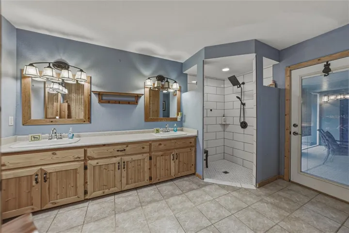 Primary bathroom--door to the right with in-glass blinds leads to the screened back porch.