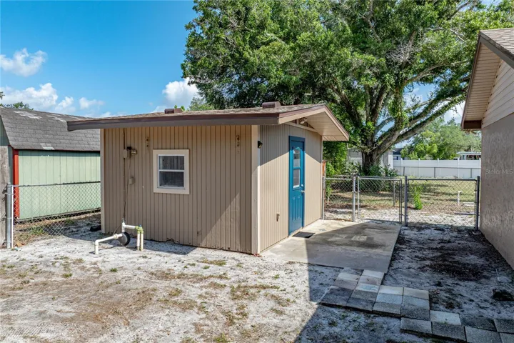 Small walk-way leads to shed from the rear porch.