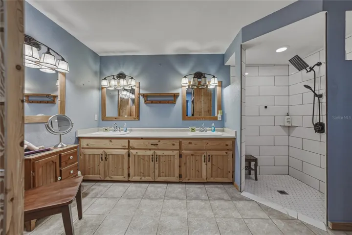 Renovated primary bath with double sinks and nice shower.