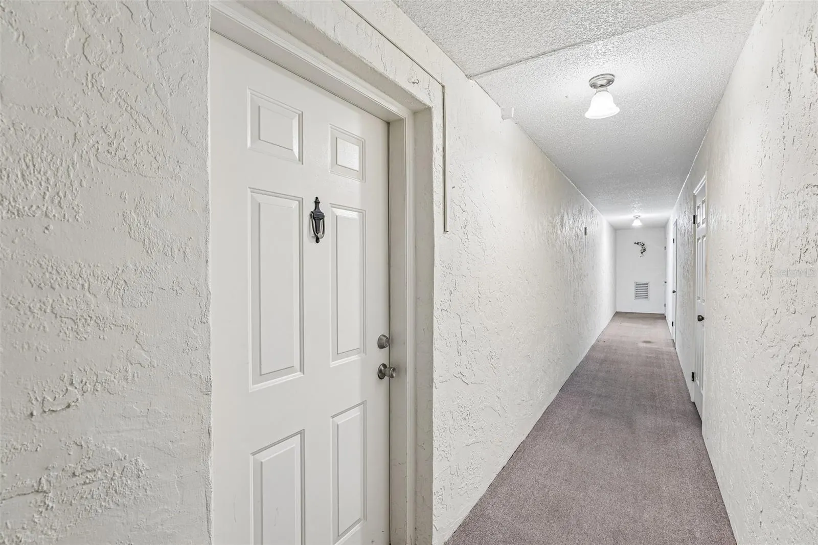 Condo door immediately on left. Garage is last door on the right