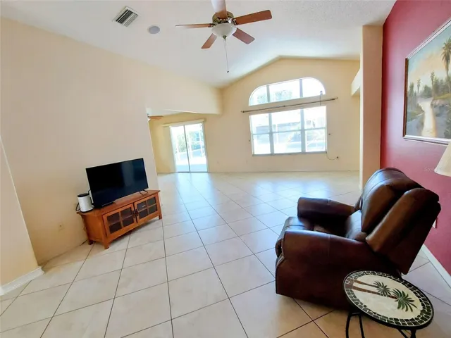 LIVING ROOM WITH WINDOW AND SLIDER TO POOL/PATIO