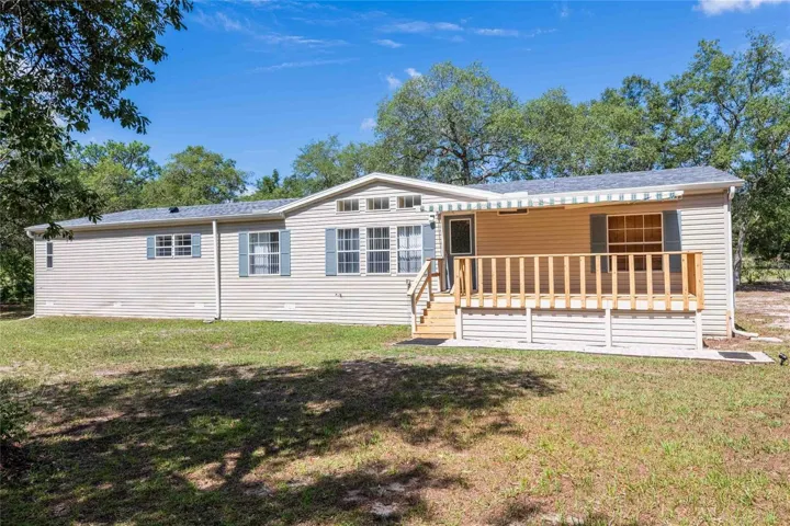 Must see 4 bedroom, 3 bath home on 1.5 acres with 2 sheds, a carport, paved driveway and 2 decks. NO HOA or CDD.