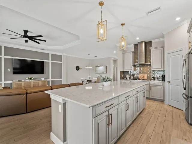 The gourmet kitchen is beautifully designed, featuring a gas stove and elegant quartz countertops.