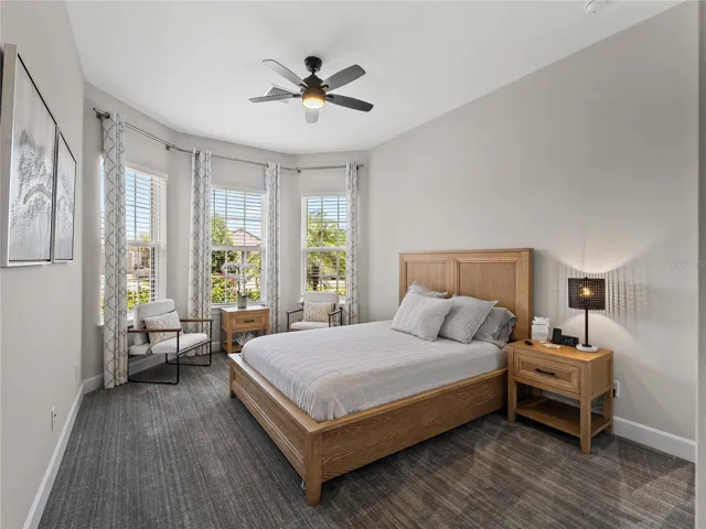 Bedroom two features soaring windows that fill the space with natural light, along with brand new carpeting that adds a fresh, cozy feel.