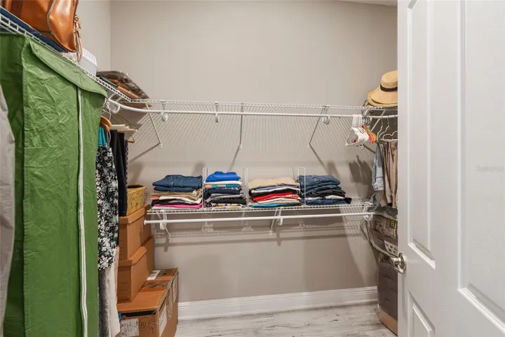 This primary suite features two walk-in closets, offering excellent storage and added convenience.