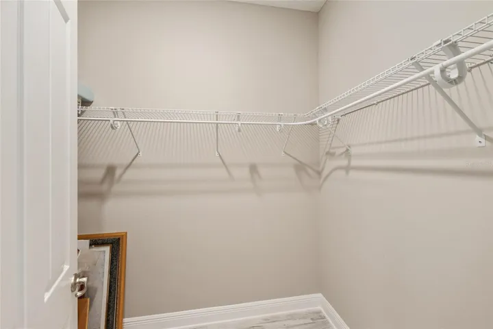 Walk-in closet in the second primary suite, offering great hanging space and convenient storage.