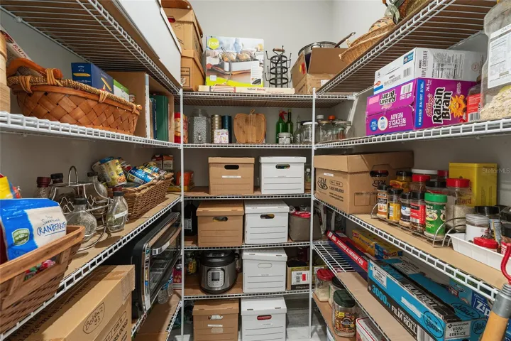 Large walk-in pantry conveniently located off the kitchen and near the two-car garage, making grocery drop-off easy. Offers abundant shelving and excellent storage.