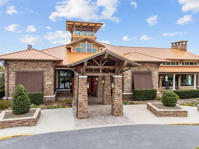 Candler Hills Clubhouse, The Lodge, offers resort-style amenities including a pool with beach entry, separate spa, outdoor fire pit, covered pavilion, indoor gathering lounge with gas fireplace and large-screen TV, grand lobby, expansive ballroom, multi-purpose rooms, catering kitchen, and so much more.