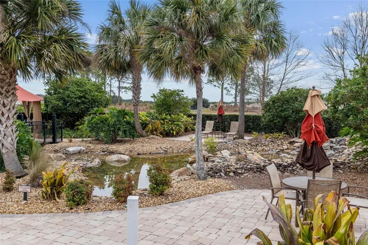 Beautiful water feature at The Lodge, enhancing the resort-style pool area with lush tropical landscaping and a relaxing atmosphere.
