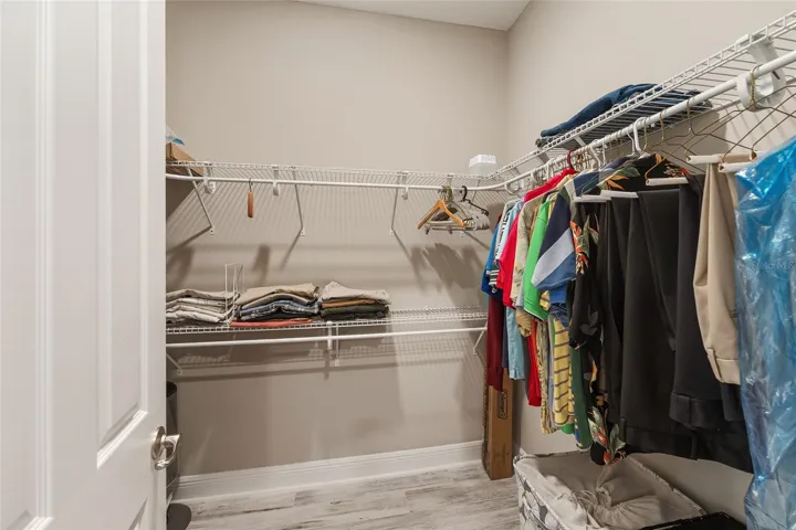 This primary suite features two walk-in closets, offering excellent storage and added convenience.