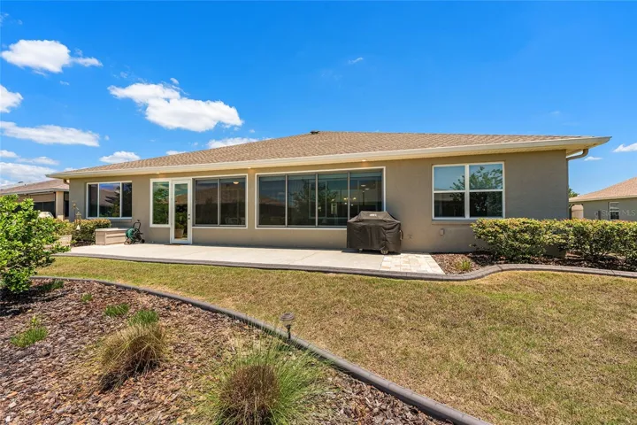 Landscaped backyard with a spacious 38’ x 10’ patio, soffit lighting, and gas line for a barbecue. Perfect for outdoor entertaining, with the grill included.