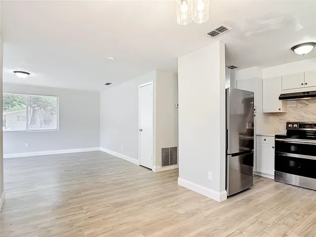 the dining room looking to the living room and the kitchen
