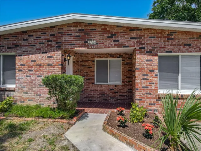 the front door is on the left in the front porch