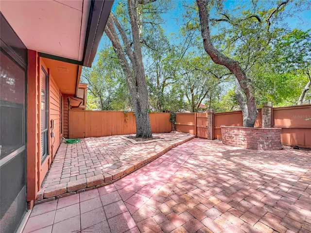 Outdoor paved backyard perfect for entertaining and relaxing. The community Pool is behind the Fence.
