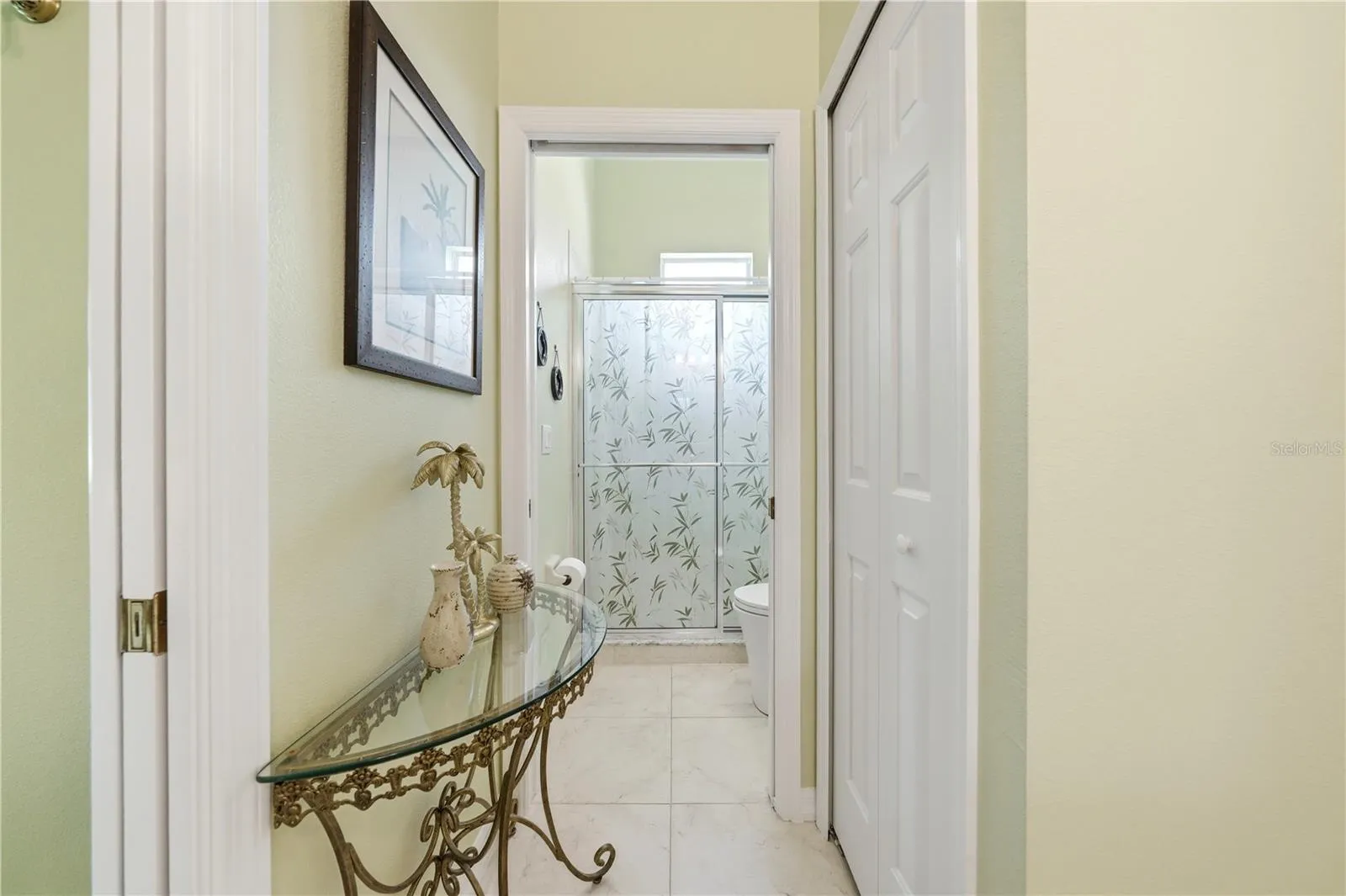 walk in tile shower - pocket door for privacy -  linen closet keeping everything at finger tips