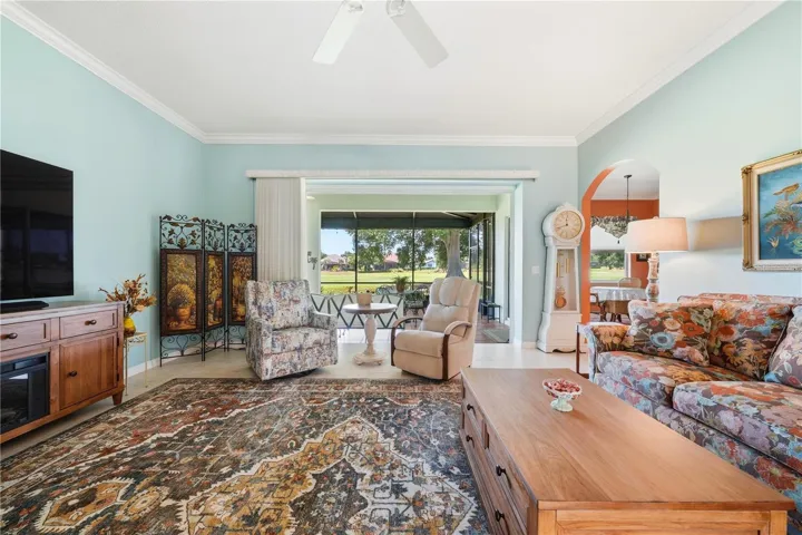 Living room sliders open 100% to lanai allowing for the magnificent view of golf course to feel part of home