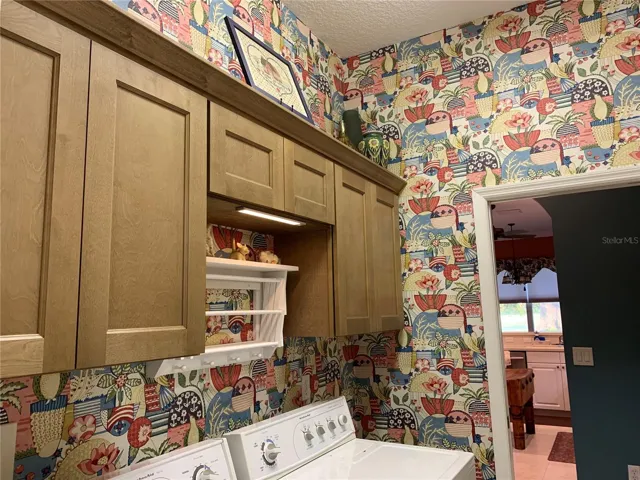 Brand new cabinets added with drying rack in laundry room (wallpaper can be easily removed)