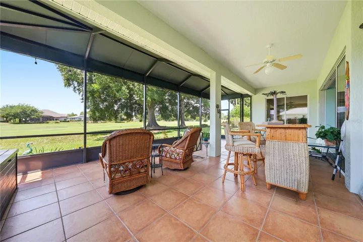 Look at this lovely lanai with terra cotta tile floors, covered and screened for enjoyment