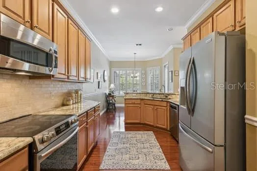 Spacious kitchen with stainless steel appliances, granite counter tops, beautiful water resistant laminate flooring and large eat-in area overlooking the screen enclosed pool and rear yard.