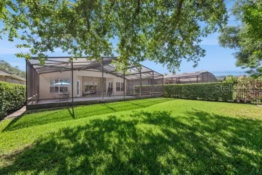Beautiful private rear yard beyond the pool.