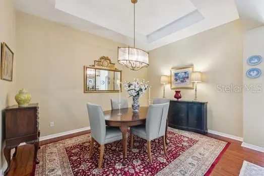 Spacious Separate Dining Room with laminate flooring and decorative ceiling with drop-down chandelier.