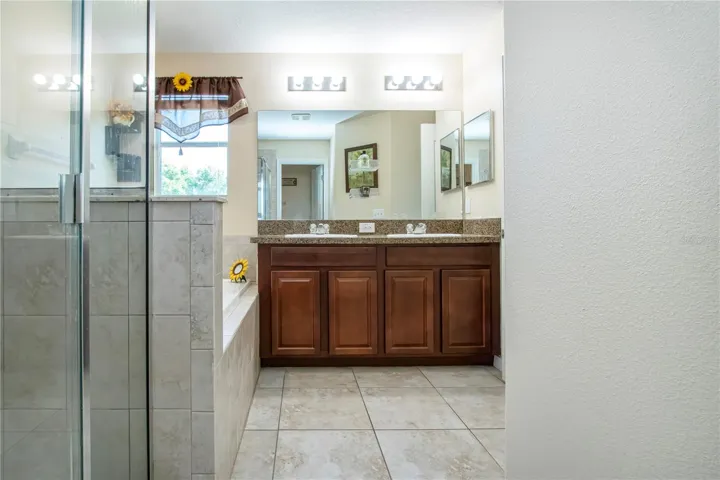 Owners Suite, Dual Sinks, Glass Shower Stall And Garden Tub