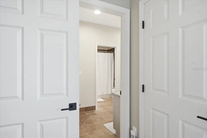 View of Jack and Jill bathroom from 3rd bedroom- walk in closet on right.