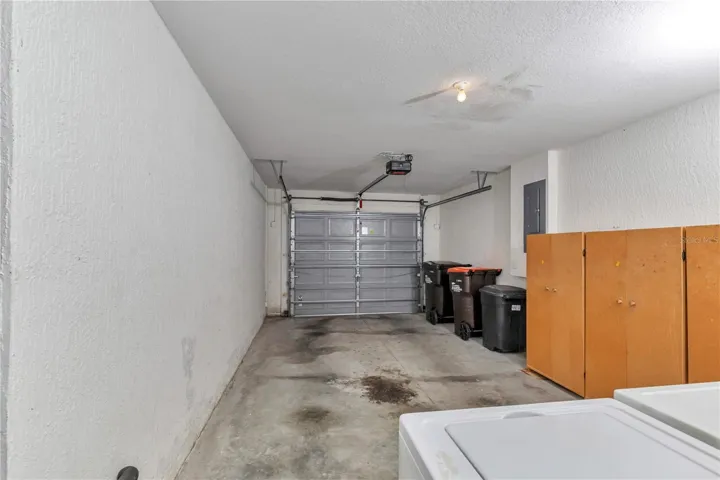 ONE CAR GARAGE WITH STORAGE CABINETS AND LAUNDRY AREA