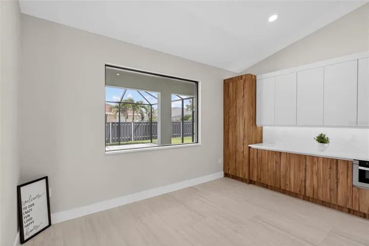 DINING ROOM w/ bright, modern design, neutral tones & vaulted ceiling w/ recessed lighting that enhances open feel.