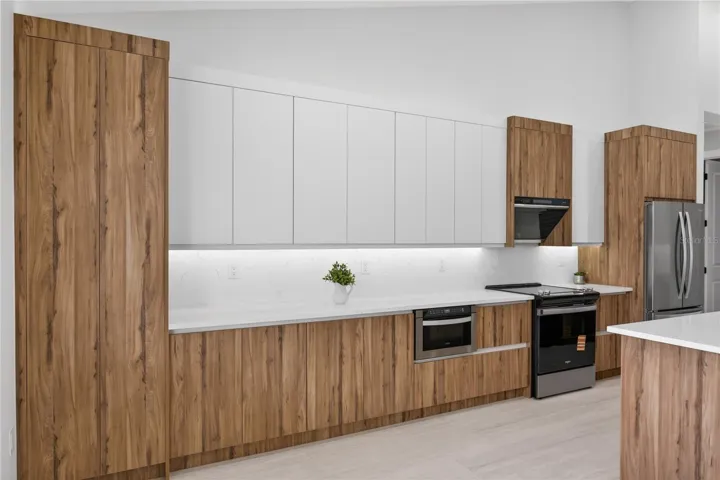 Equipped w/ SS appliances, French-door refrigerator, microwave, smooth-top range & angular EURO-STYLE hood & dishwasher.