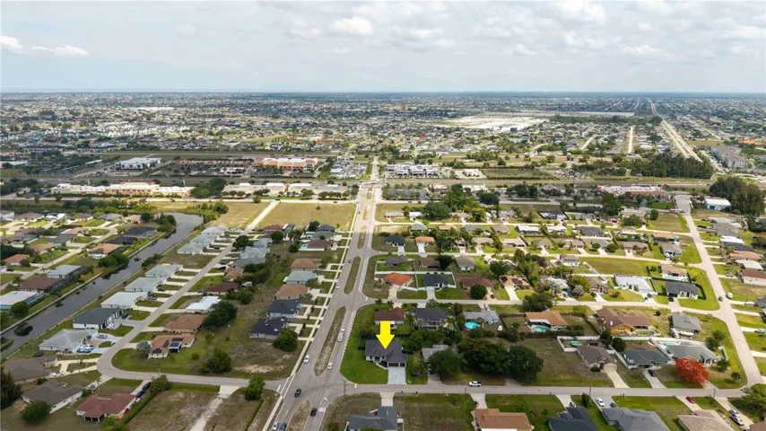 Located in SW Cape Coral, offers NO FLOOD INSURANCE, durable METAL ROOF, 3-CAR GARAGE & CITY WATER & SEWER!