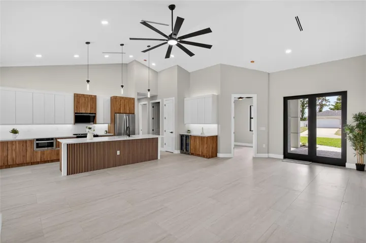 GORGEOUS CHEF’S KITCHEN showcases sophisticated CUSTOM CABINETRY w/ NATURAL WOOD-GRAIN finish paired w/ sleek WHITE FLAT-PANEL UPPER CABINETS.