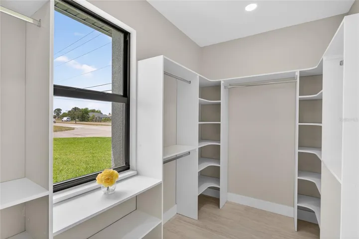 WALK-IN CLOSET w/ BUILT-IN SHELVING & HANGING RACKS