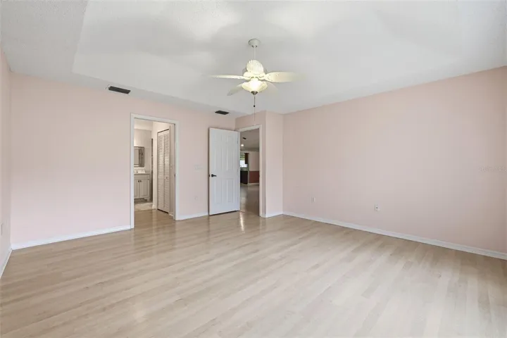 Primary bedroom with en-suite full bath. Two walk-in closets in hallway to the bathroom.
