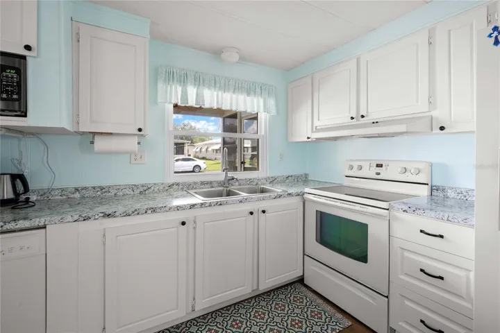 The kitchen has a combination of new cabinetry and new door fronts