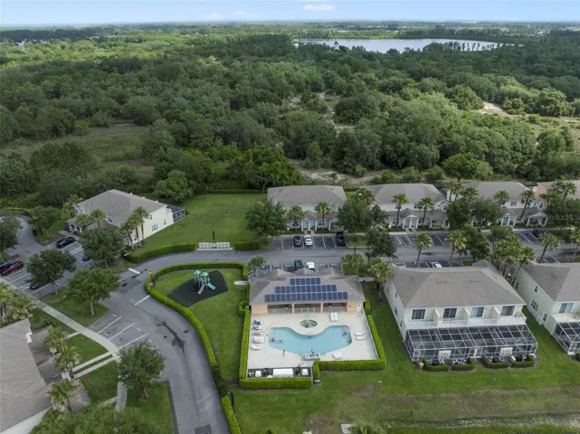 Community pool set against a tranquil wooded backdrop!
